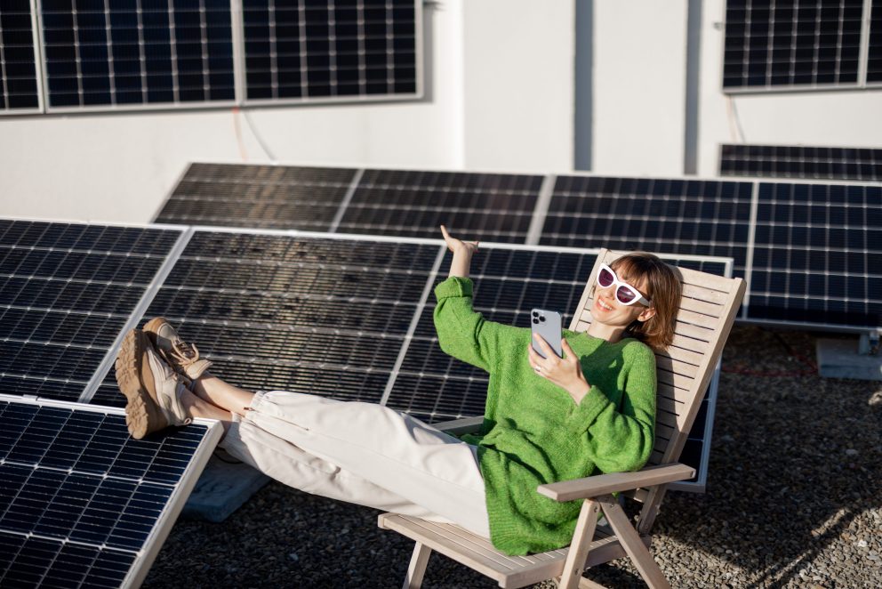 Happy woman on rooftop with a solar station