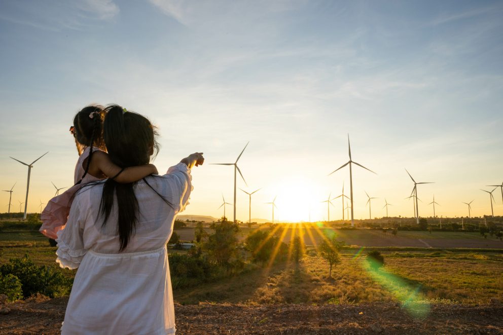 Wind turbines are alternative electricity sources, the concept of sustainable resources, People in the community with wind generators turbines, Renewable energy
